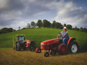 Farmer granpa with a tractor in the field